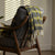 yellow and black unique plaid throw blanket styled beautifully over the chair