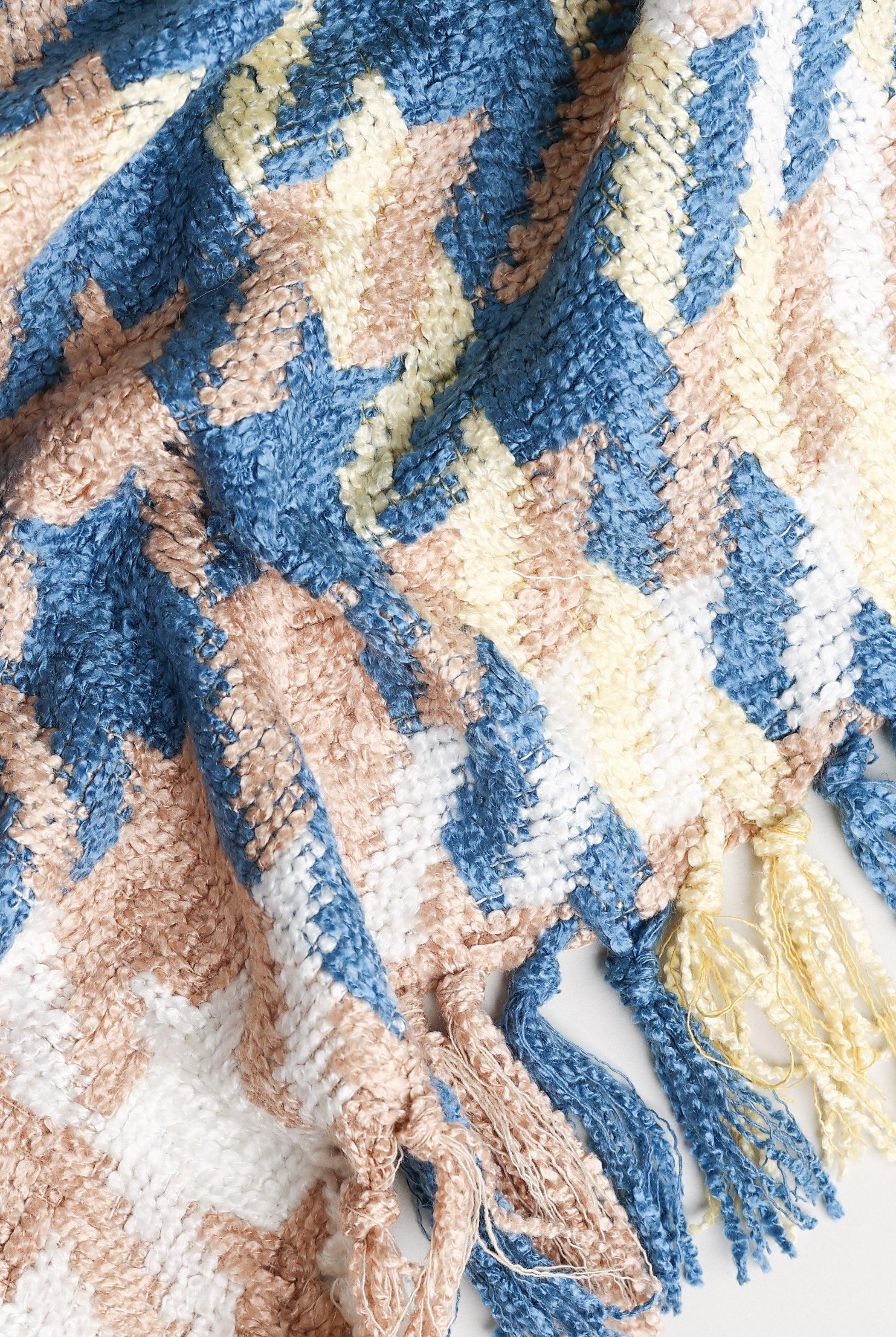 boucle's yellow beige and blue houndstooth throw blanket styled with tassels