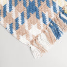 beige blue white and yellow houndstooth throw blanket displaying to show tassels