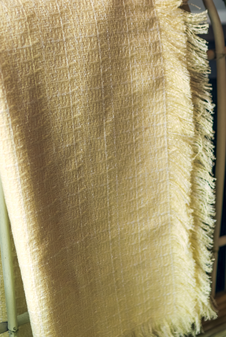 light yellow throw blanket over chair