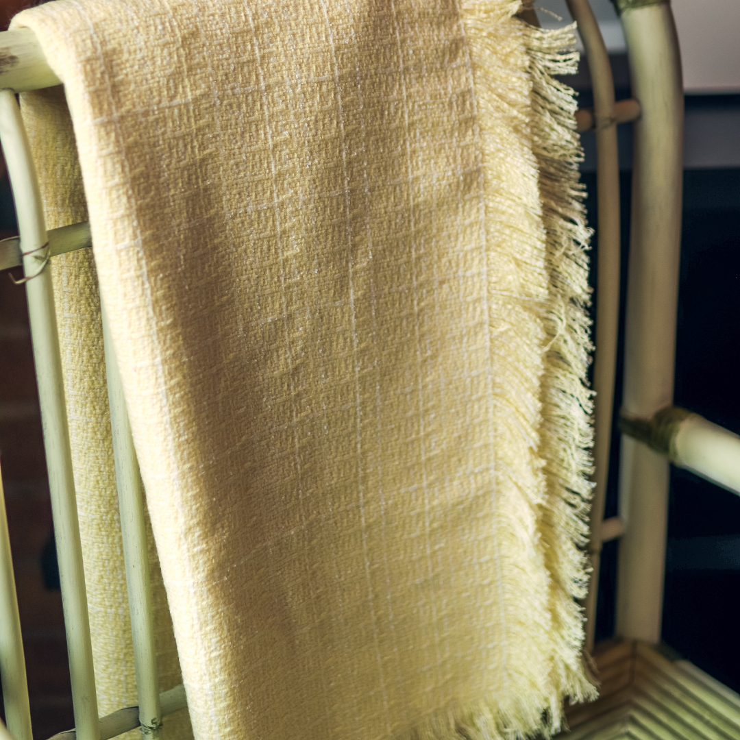 light yellow throw blanket over chair