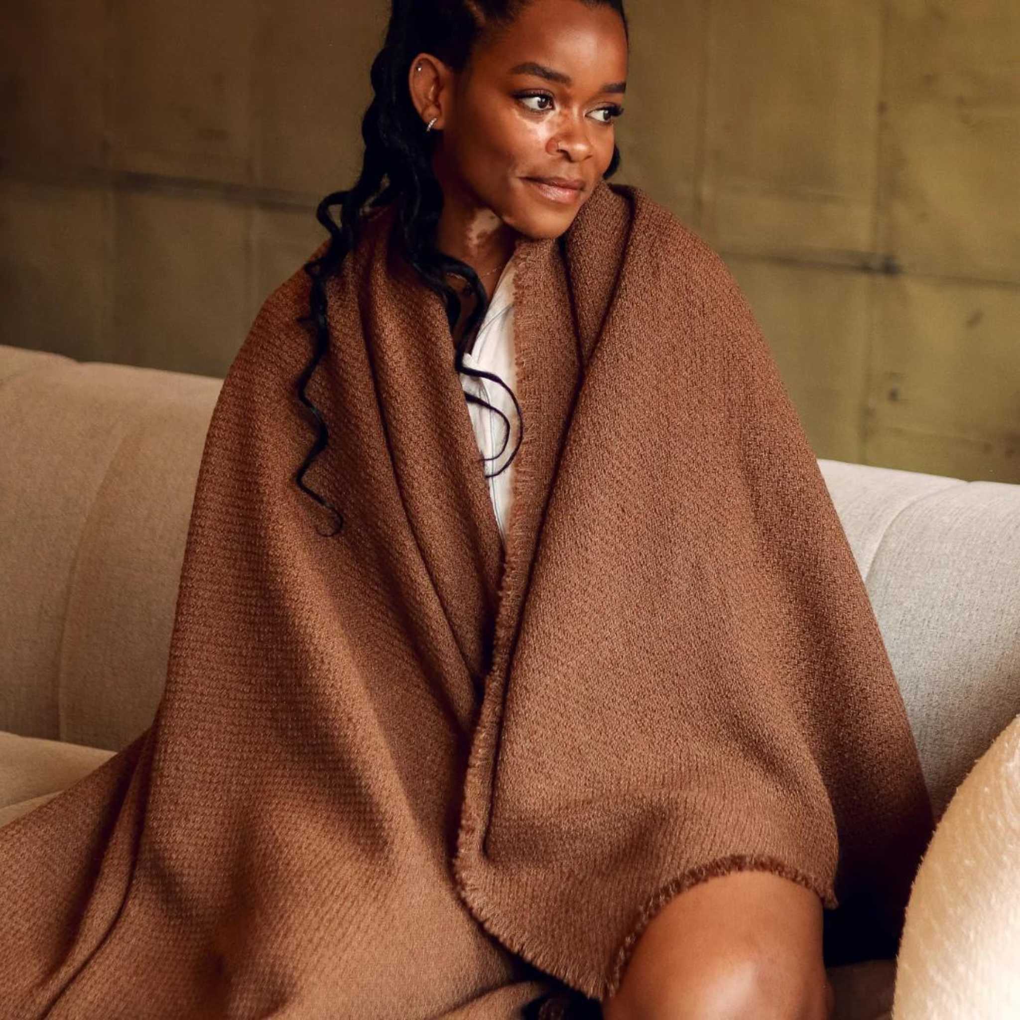 cozy soft brown throw blanket in use for warmth