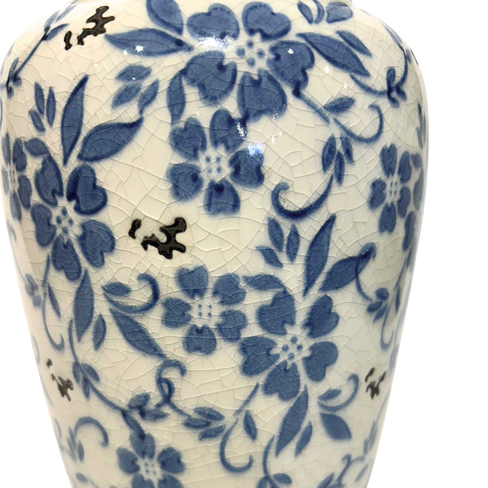 white crackled designed vase with blue decorative flowers on its side