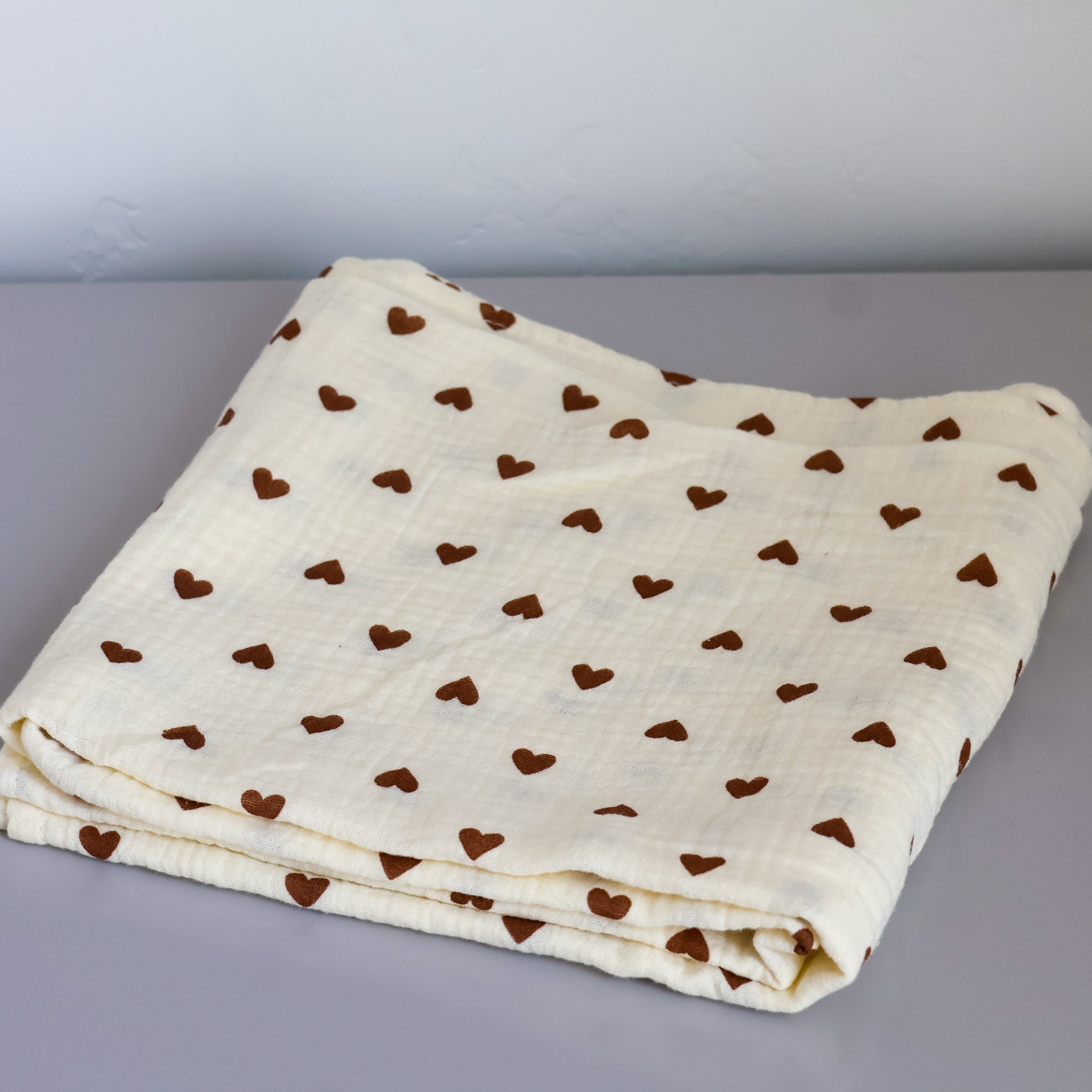 boucle home's brown heart swaddle blanket