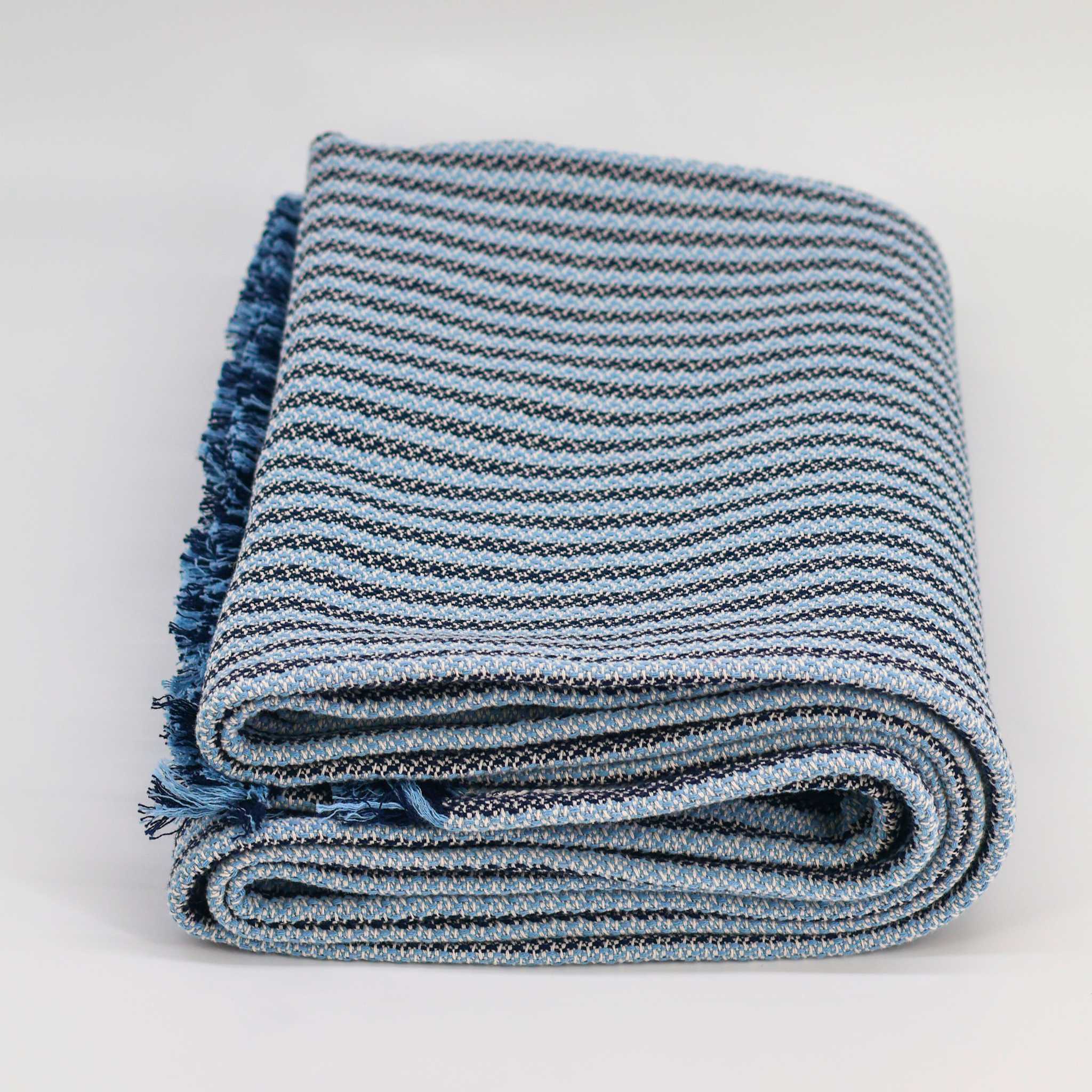 folded blue colored thick throw blanket with short fringe decorative blue throw blanket