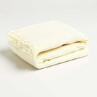 our pale yellow folded throw blanket with a fringe