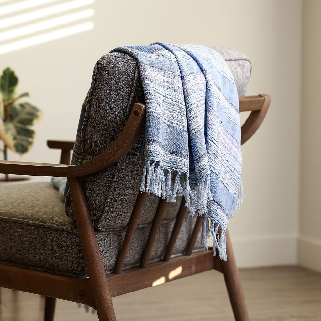 jacquard periwinkle throw blanket draped and styled over a couch