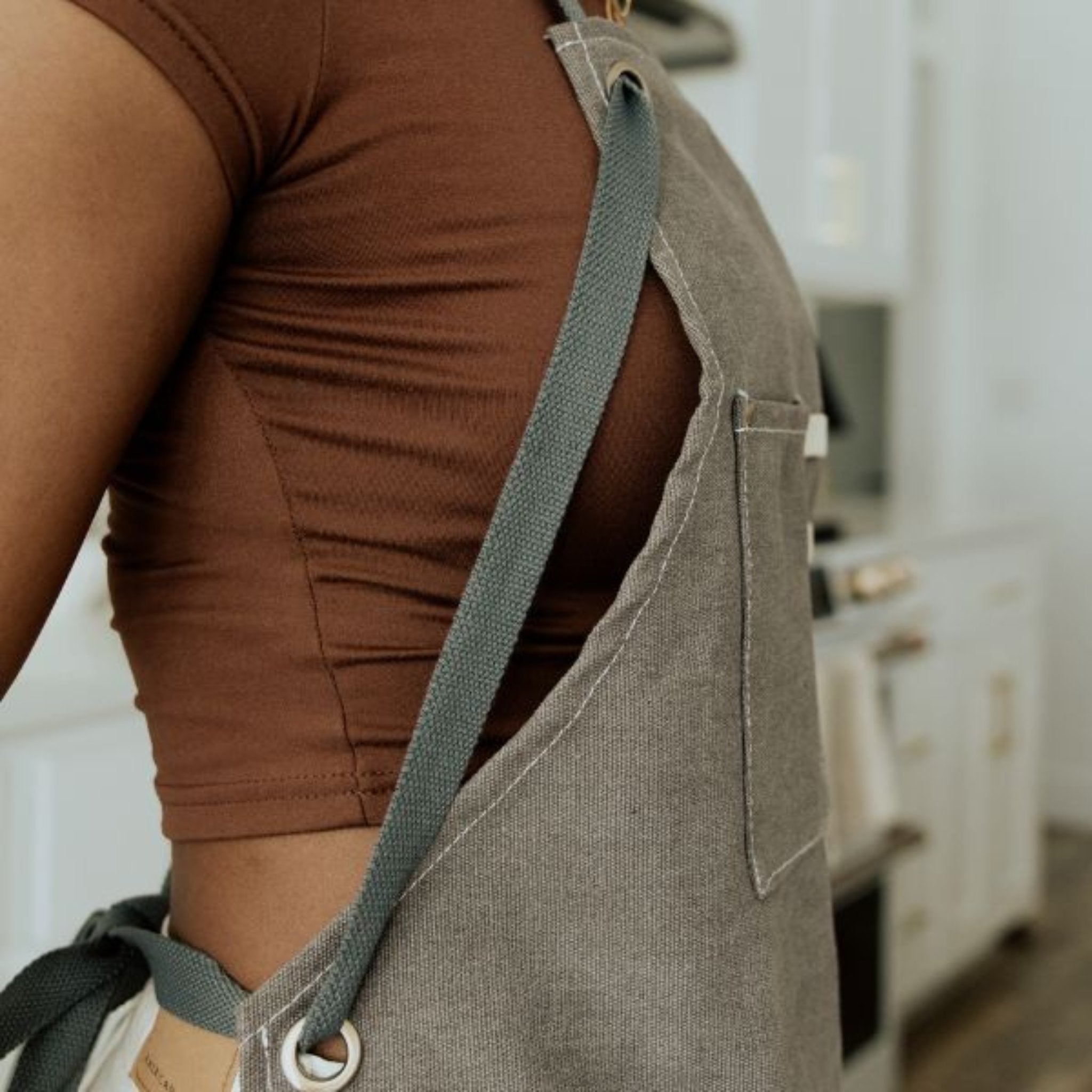 side of brown apron with pockets